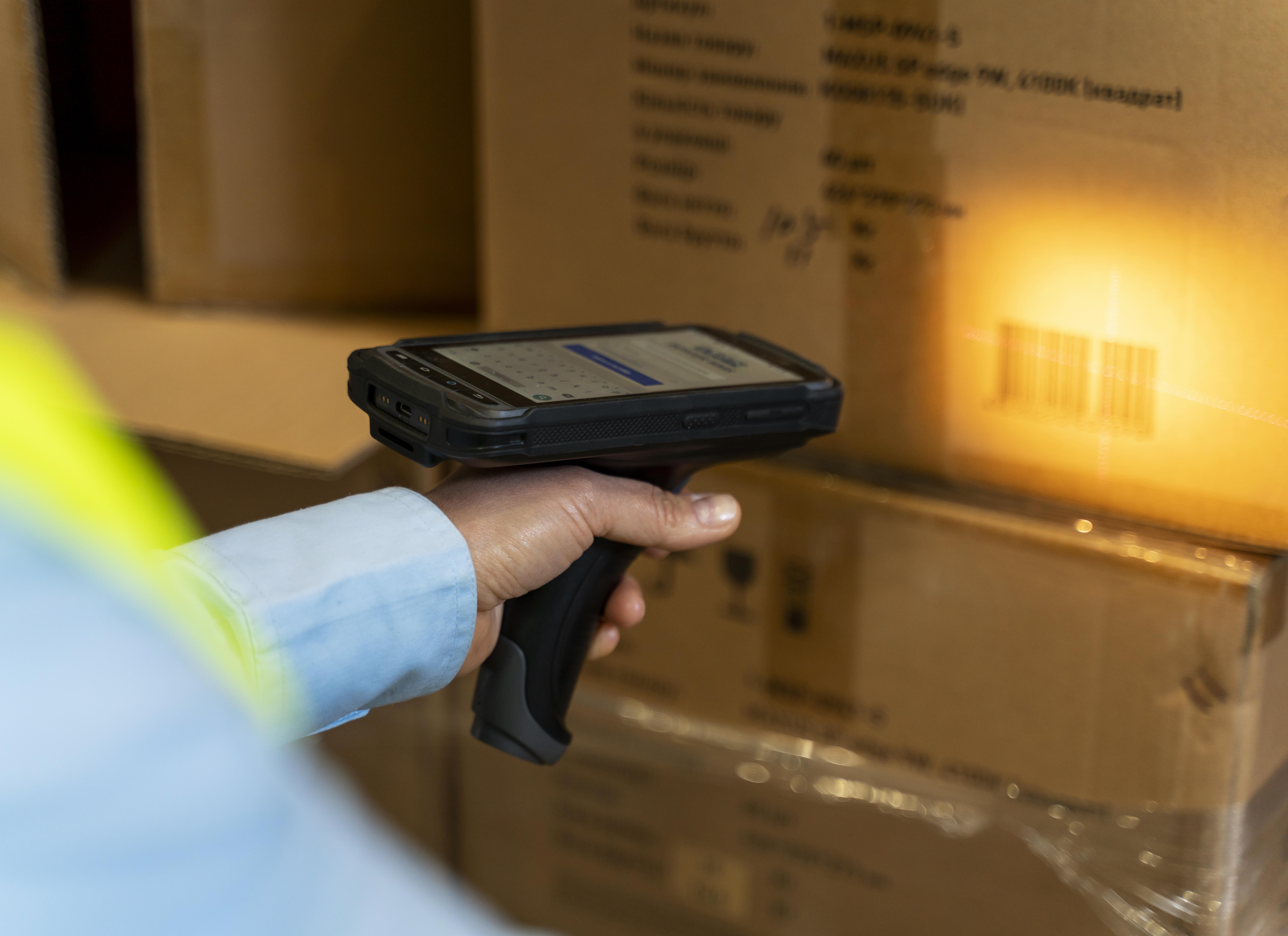 A warehouse manager using a label reader for better warehouse management.