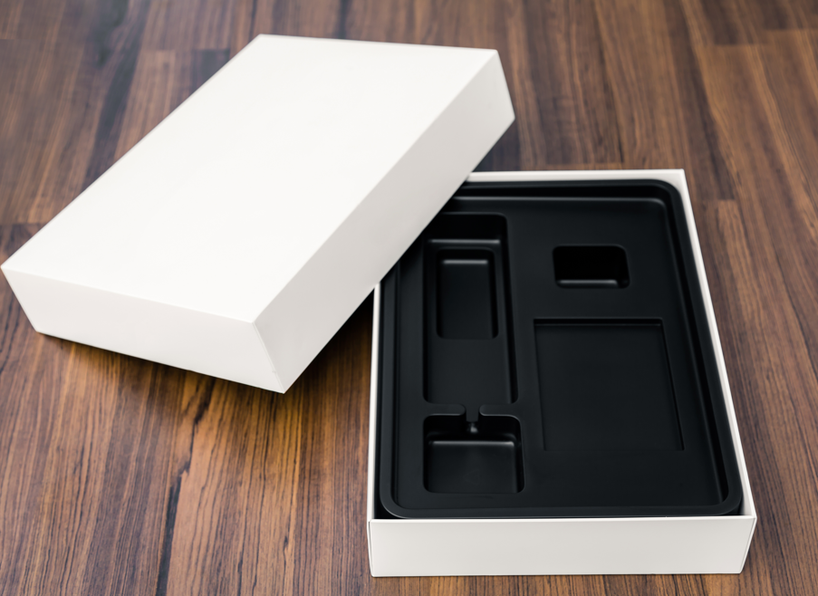Minimalist packaging with black tray insert, ideal for tech devices or accessory presentation.