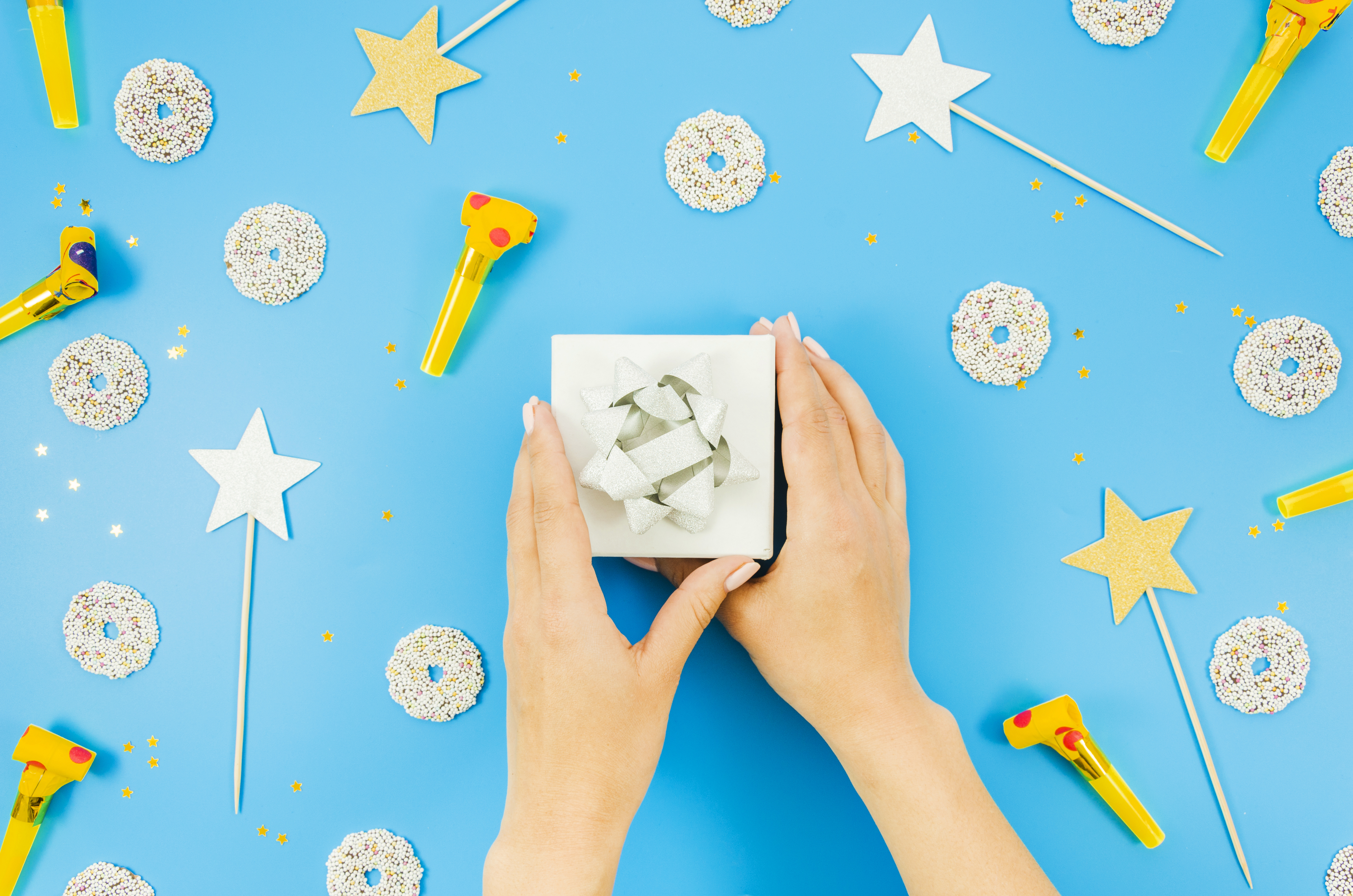 Close-up of eco-friendly gift wrap trends for 2025: recycled kraft paper, bold metallic accents, dried flower sprigs, and hand-tied twine bows